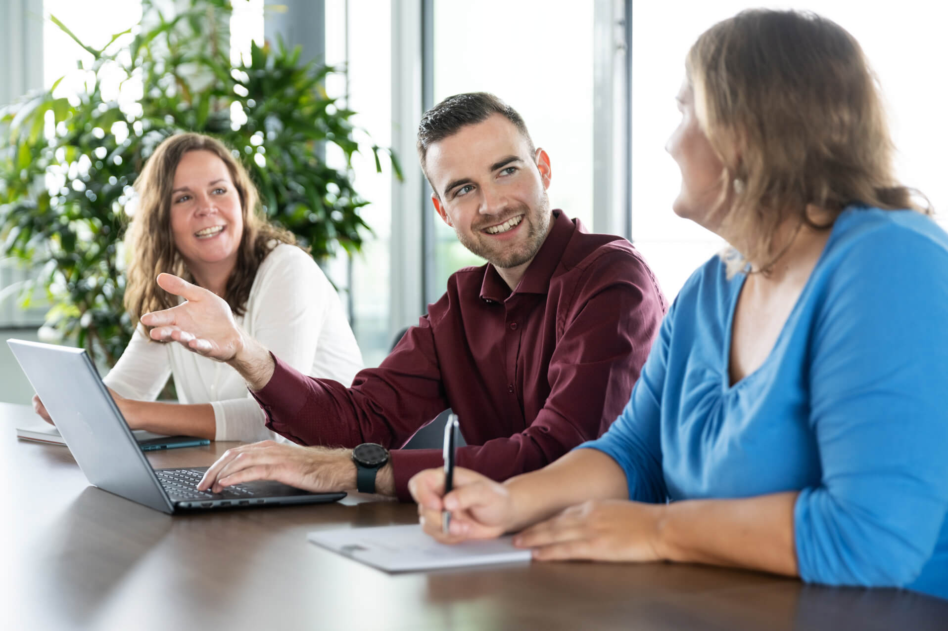 Colleagues in a meeting at a conference table.