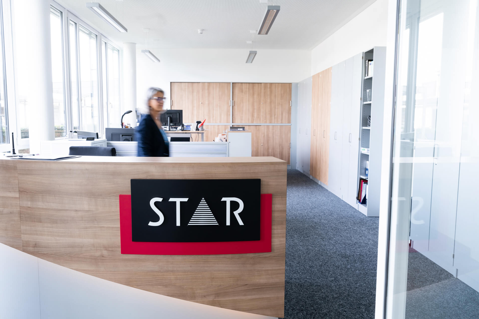 STAR reception with large STAR logo and an employee in motion.