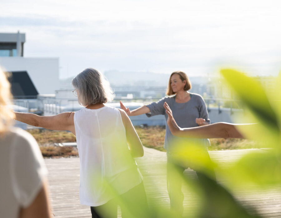 A group of STAR employees doing fitness training on the roof terrace of the STAR building.