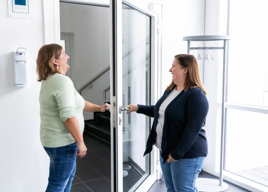 A STAR employee holds the door open for her colleague in the STAR building.