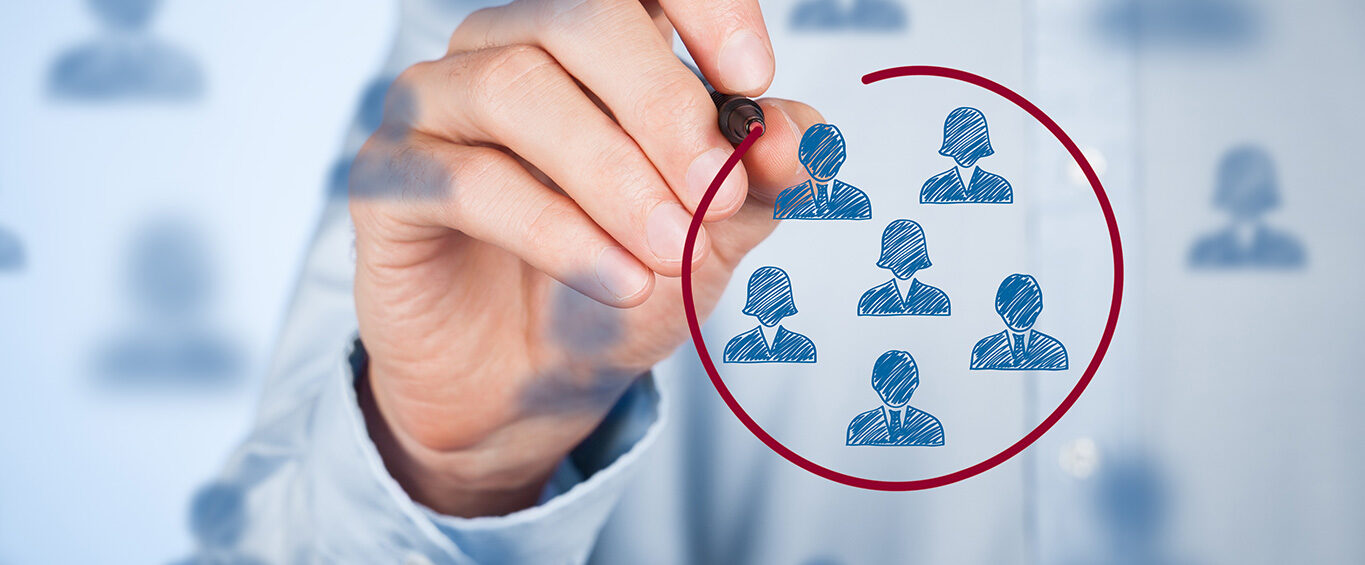 Hand selects employee icons with pen on glass display.