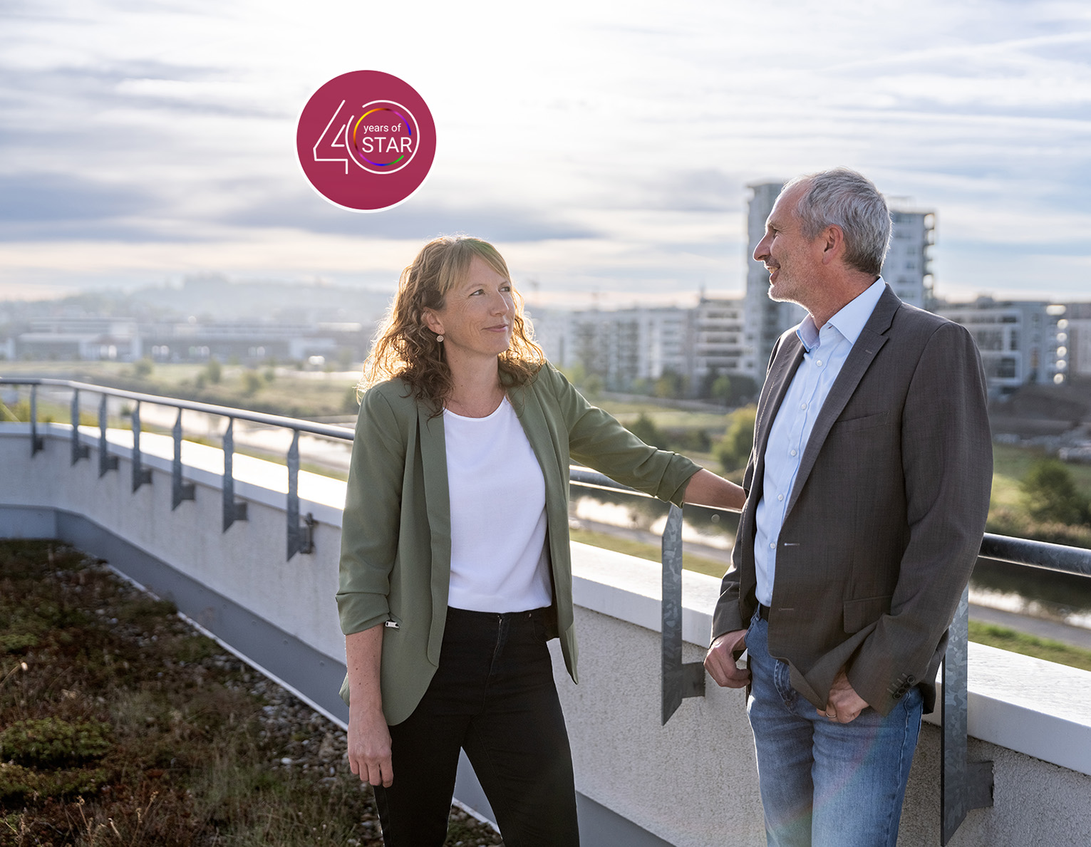 Zwei STAR Mitarbeiter stehen auf der Dachterasse des STAR Gebäudes mit Panoramablick über das Flugfeld Sindelfingen. 40 Jahre STAR Siegel