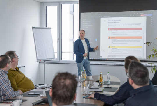 A presentation on technical documentation is being shown to a group.